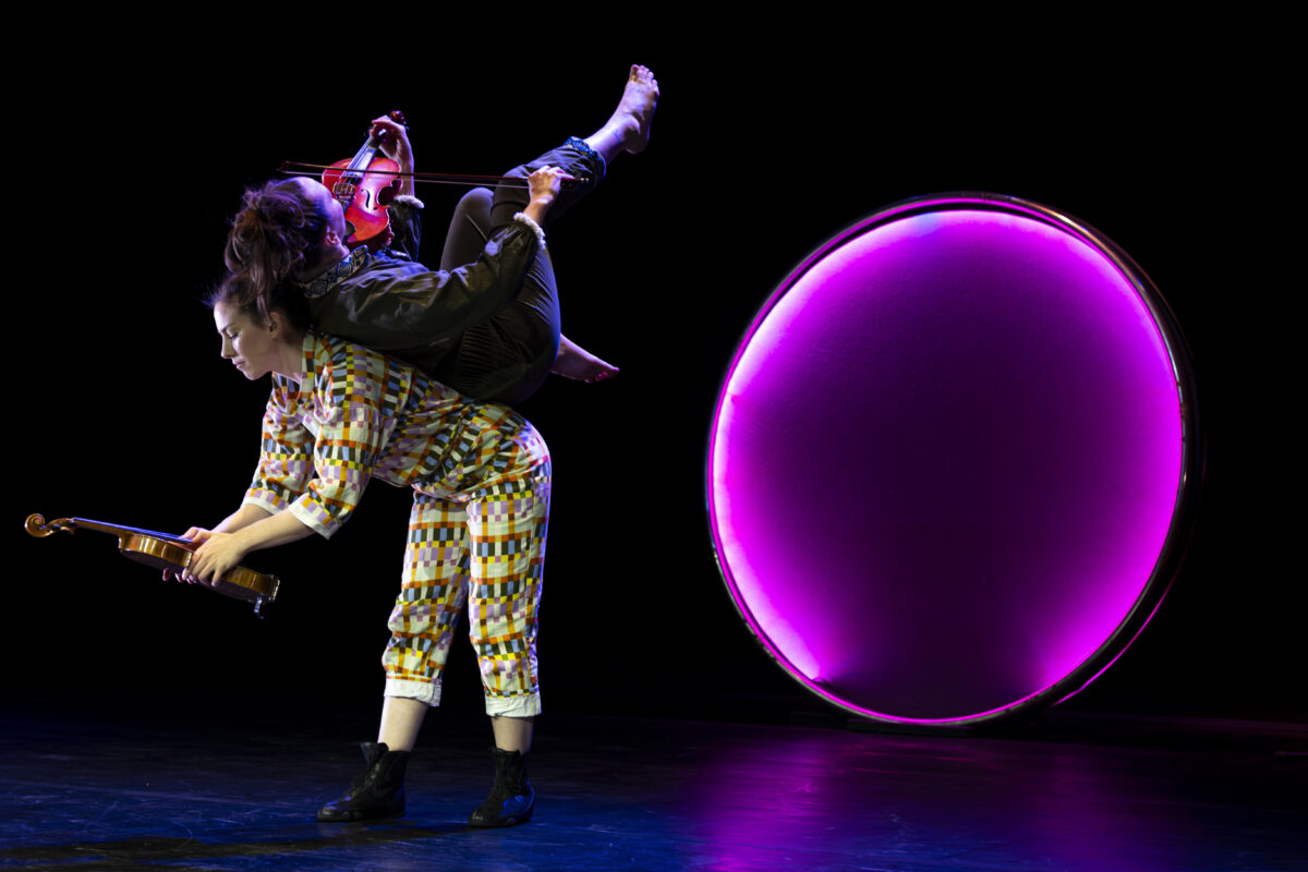 Two circus artists plus a big enlightened ball