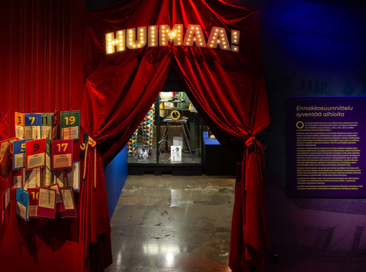 An entrasce to the circus exhibition Huimaa! with red velvet curtains